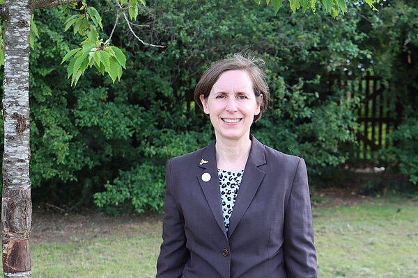 Christine Adali standing by a tree