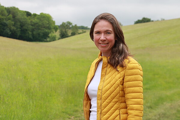 Anna in yellow jacket in the countryside