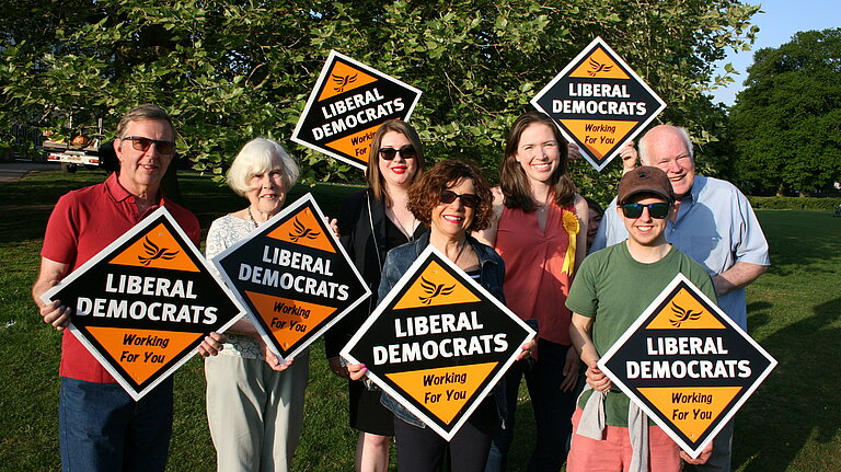 Group of Lib Dems holding sign boards