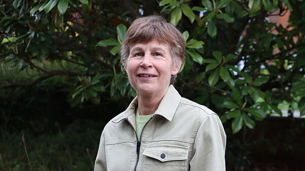 Catherine Johnson standing in front of a tree
